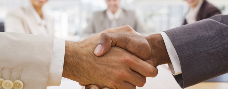 Portrait of happy businesspeople shaking hands